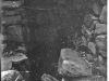 Negative of a photo of a possible mine entrance.