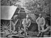 photo of steam engine with writing on the back; "Man to left is