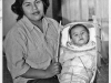 photo of Pomo woman and baby in traditional baby basket.