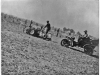 photo of man on tractor with writing on back "Henry Benson &